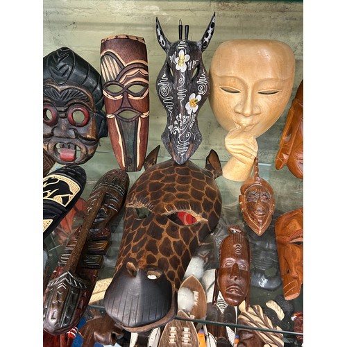 226 - SHELF OF CARVED AFRICAN SOUVENIR FACE MASKS