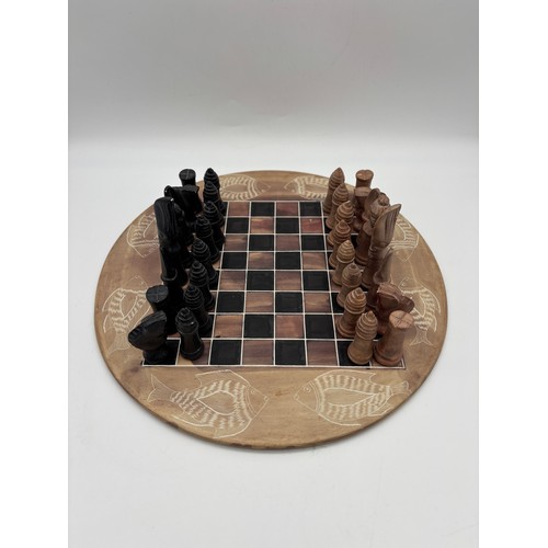 443 - CIRCULAR CARVED SOAP STONE CHESS BOARD AND CHESS PIECES