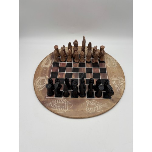 443 - CIRCULAR CARVED SOAP STONE CHESS BOARD AND CHESS PIECES