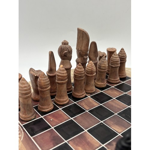 443 - CIRCULAR CARVED SOAP STONE CHESS BOARD AND CHESS PIECES