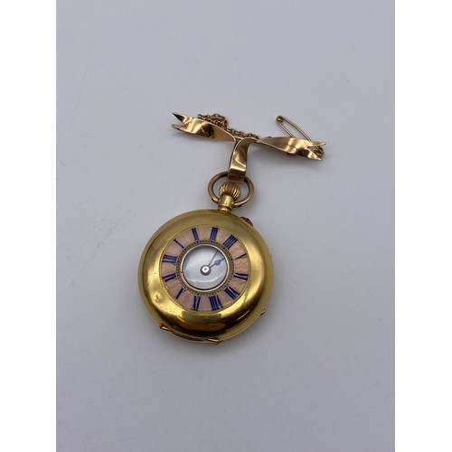 536 - 18K GOLD CASED FOB WATCH WITH BLUE ENAMEL CHAPTER RING ON 9CT GOLD BOW TIE BROOCH 35G APPROX OVERALL