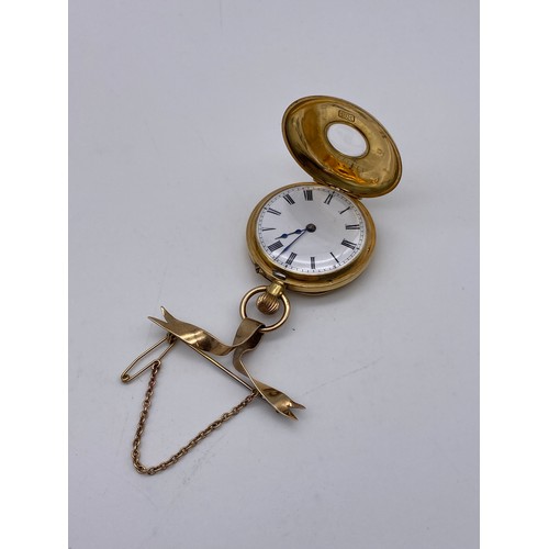 536 - 18K GOLD CASED FOB WATCH WITH BLUE ENAMEL CHAPTER RING ON 9CT GOLD BOW TIE BROOCH 35G APPROX OVERALL