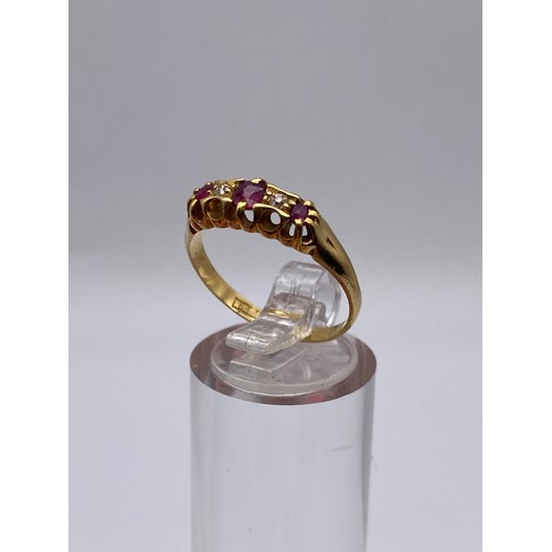 527 - UNMARKED YELLOW METAL RUBY AND DIAMOND CHANNEL SET RING 3.5G APPROX.