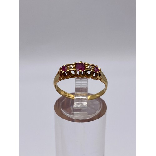 527 - UNMARKED YELLOW METAL RUBY AND DIAMOND CHANNEL SET RING 3.5G APPROX.