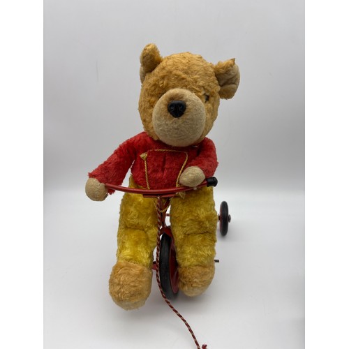 373 - SMALL PLUSH TEDDY BEAR RIDING A TRICYCLE