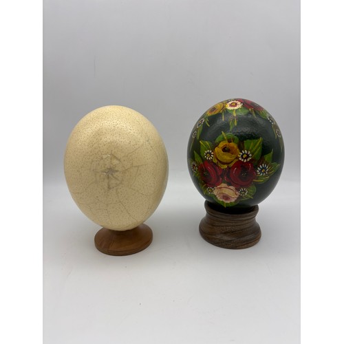 533 - TWO DECORATIVE PAINTED EGGS ON STANDS