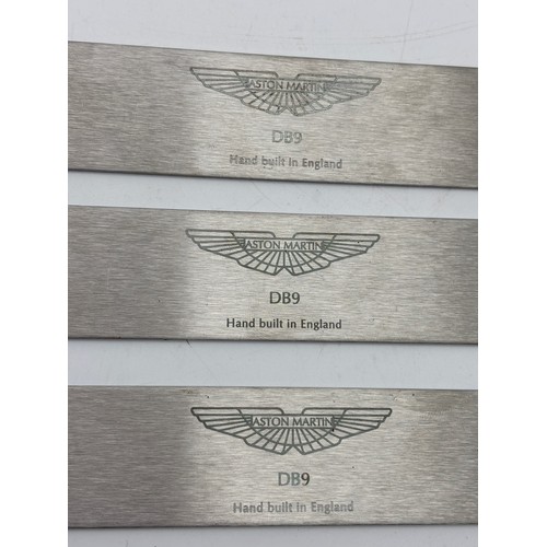 414 - THREE ASTON MARTIN DB9 PLAQUES