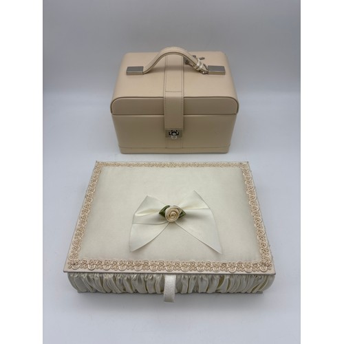 422 - CREAM JEWELLERY BOX CONTAINING SOME COSTUME JEWELLERY AND A PADDED BOX OF BEADS