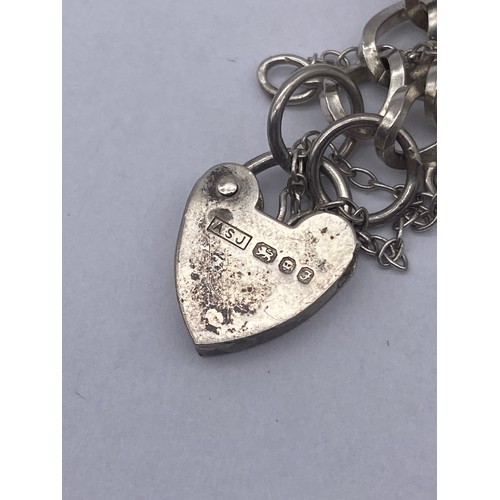 455 - SMALL SILVER AND WHITE METAL NOVELTY CHARM BRACELET