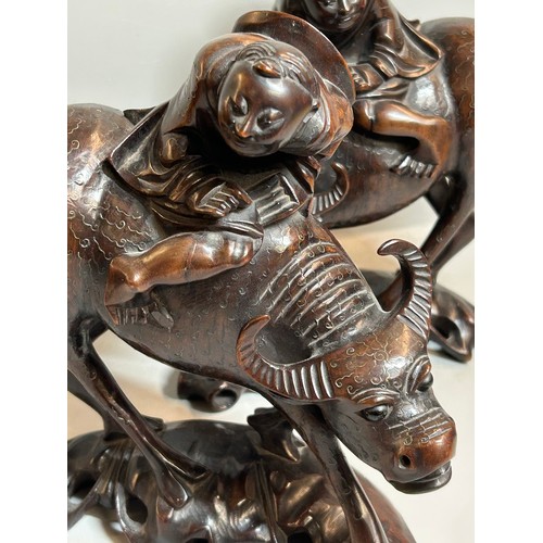 406 - PAIR OF CHINESE CARVED HARDWOOD GROUPS OF FIGURES ASTRIDE OXEN