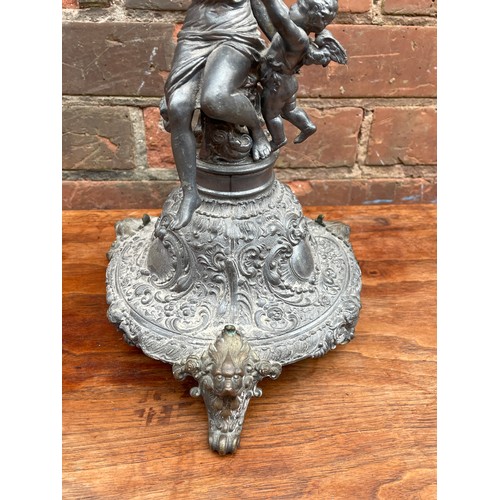 409 - BASE METAL MAIDEN AND CHERUB FIGURAL CANDLE HOLDER