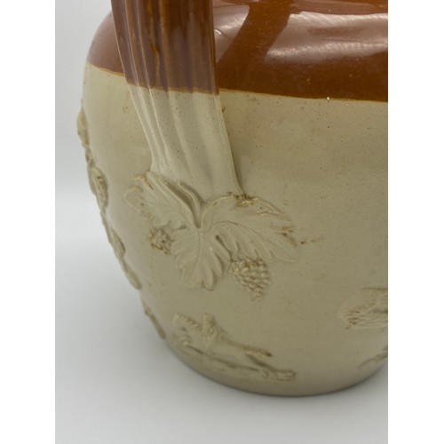 594 - LARGE STONEWARE RELIEF MOULDED JUG WITH METAL LID