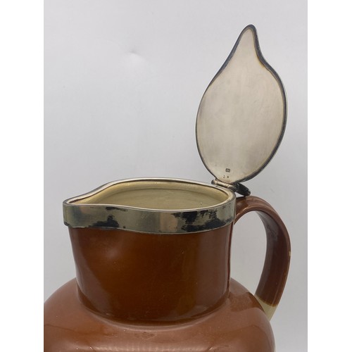 594 - LARGE STONEWARE RELIEF MOULDED JUG WITH METAL LID