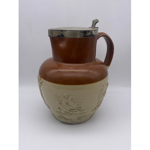 594 - LARGE STONEWARE RELIEF MOULDED JUG WITH METAL LID