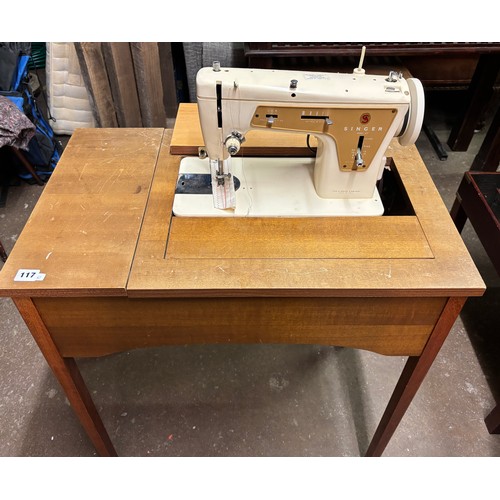 117 - ELECTRIC SEWING MACHINE IN TABLE