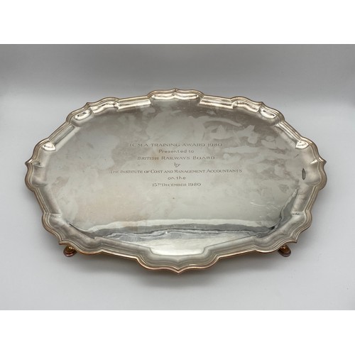 619 - SHEFFIELD SILVER GARRARD AND CO. SERPENTINE EDGED PRESENTATION TRAY ON RAISED LEGS 42 OZ APPROX.