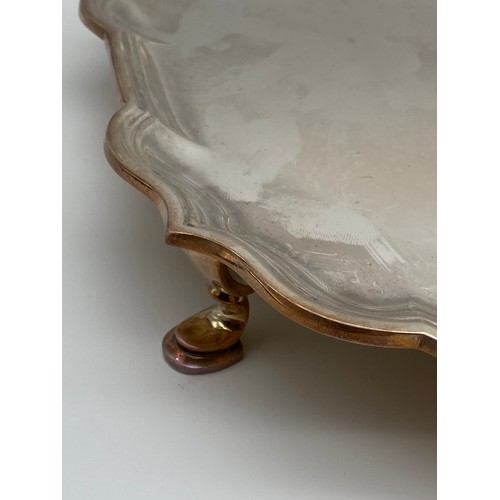619 - SHEFFIELD SILVER GARRARD AND CO. SERPENTINE EDGED PRESENTATION TRAY ON RAISED LEGS 42 OZ APPROX.