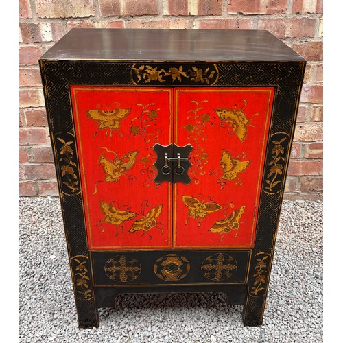 21 - CHINESE INFLUENCED RED AND BLACK LACQUERED TWO DOOR CABINET