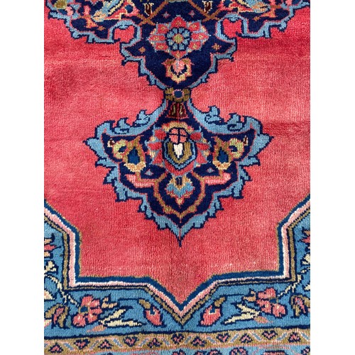 6 - EARLY 20TH CENTURY CAUCASIAN CARPET WITH CENTRAL MULTI PATTERNED MEDALLION ON A RED GROUND WITHIN MU... 