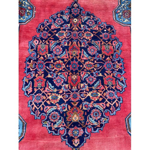 6 - EARLY 20TH CENTURY CAUCASIAN CARPET WITH CENTRAL MULTI PATTERNED MEDALLION ON A RED GROUND WITHIN MU... 