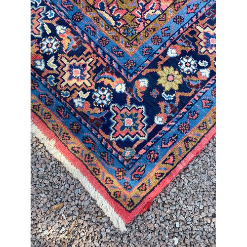 6 - EARLY 20TH CENTURY CAUCASIAN CARPET WITH CENTRAL MULTI PATTERNED MEDALLION ON A RED GROUND WITHIN MU... 