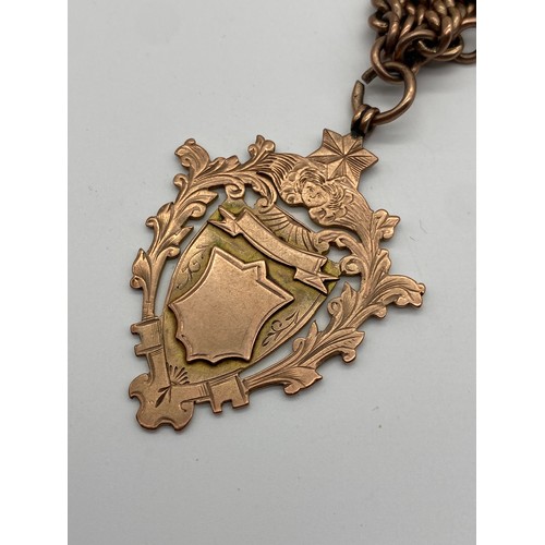 648 - 9CT ROSE GOLD ALBERT CHAIN WITH T BAR, SNAP SWIVEL FASTENER AND LARGE SHIELD FOB 75.2G APPROX