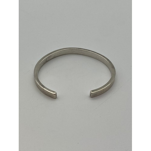 598 - UNMARKED WHITE METAL BANGLE 31.9G