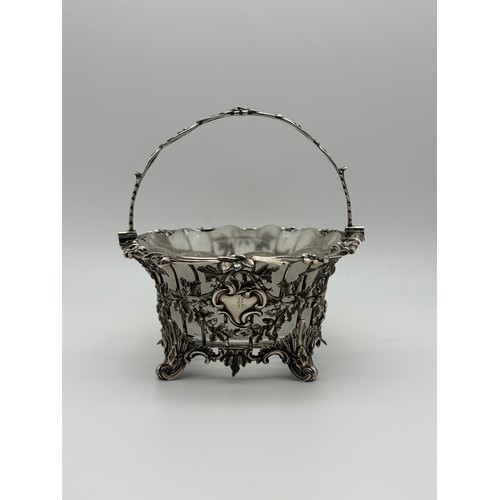 529 - 19TH CENTURY LONDON SILVER GLASS LINED BASKET WITH SWING HANDLE DECORATED WITH ACORNS ON TURNED FEET... 