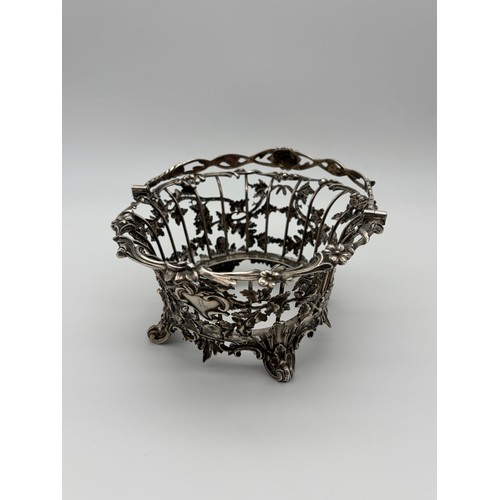 529 - 19TH CENTURY LONDON SILVER GLASS LINED BASKET WITH SWING HANDLE DECORATED WITH ACORNS ON TURNED FEET... 