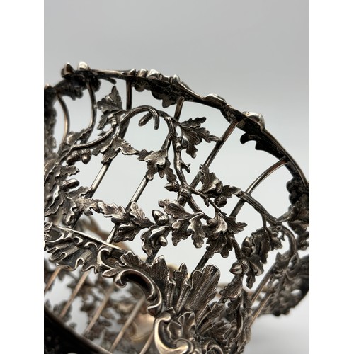 529 - 19TH CENTURY LONDON SILVER GLASS LINED BASKET WITH SWING HANDLE DECORATED WITH ACORNS ON TURNED FEET... 