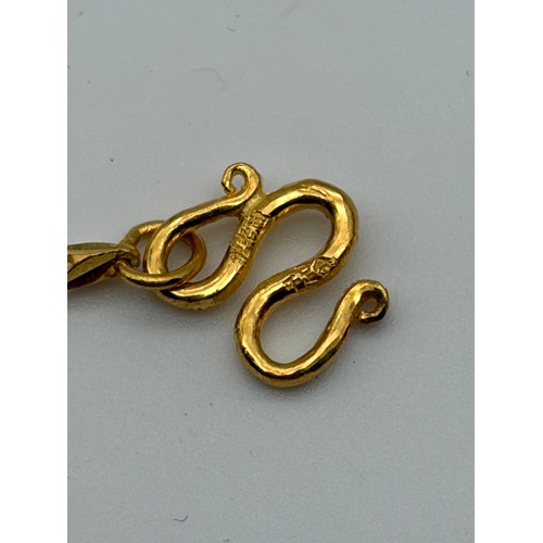 535 - CHINESE YELLOW METAL CHAIN NECKLACE WITH FLORAL HEART DROPPER 14G APPROX.