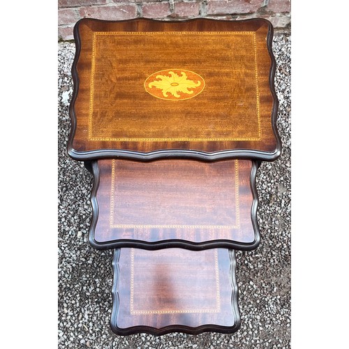 67 - NEST OF THREE MAHOGANY SERPENTINE INLAID SPIDER LEG TABLES
