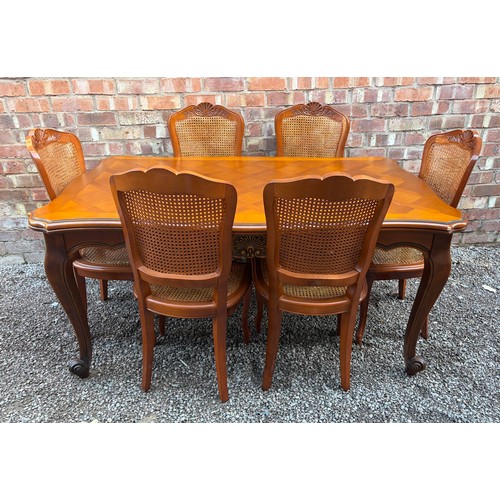 63 - REPRODUCTION NOVE STYLE FRENCH EXTENDING DRAWER LEAF DINING TABLE WITH SIX BERGERE CANED CHAIRS