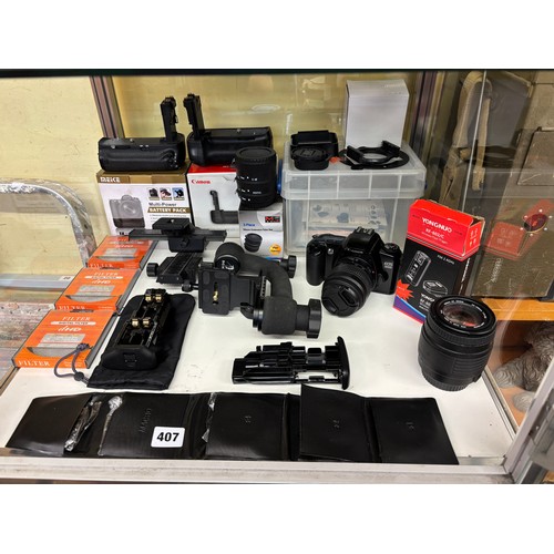 407 - SHELF OF CANON EOS 3000 CAMERA, LENSES, FILTERS MULTI POWER BATTERY PACK