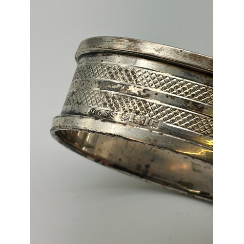 638 - BIRMINGHAM SILVER OVAL-SHAPED NAPKIN RING AND 800 WHITE METAL NAPKIN RING
