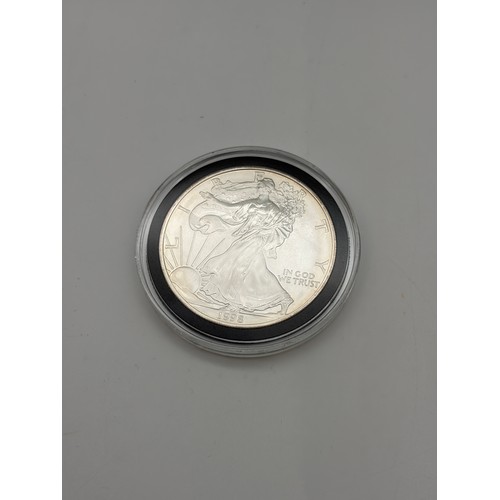 569 - SILVER COINS OF THE UNITED STATES OF AMERICA MADE UP OF 15 SILVER 1OZ DOLLARS AND HALF DOLLAR