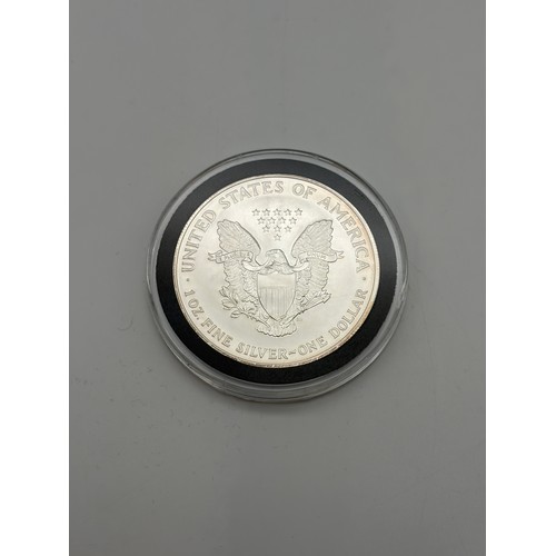 569 - SILVER COINS OF THE UNITED STATES OF AMERICA MADE UP OF 15 SILVER 1OZ DOLLARS AND HALF DOLLAR