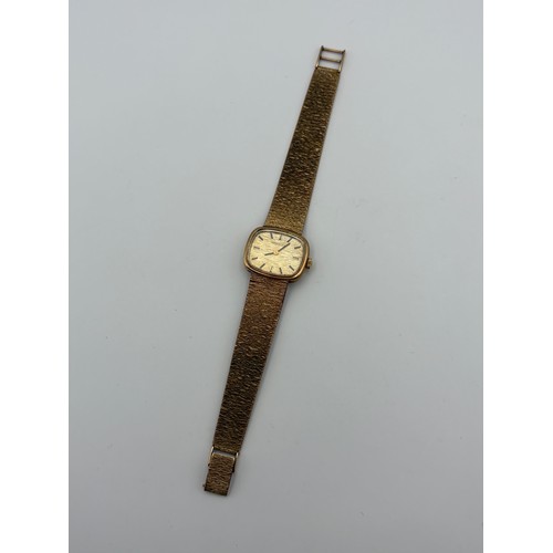 464 - LADIES LONGINES 9CT GOLD WRISTWATCH ON 9CT GOLD BARK EFFECT BRACELET STRAP 38G OVERALL.