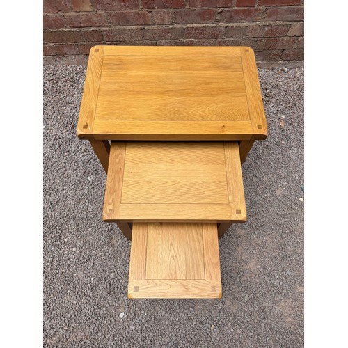 44 - NEST OF THREE LIGHT OAK TABLES