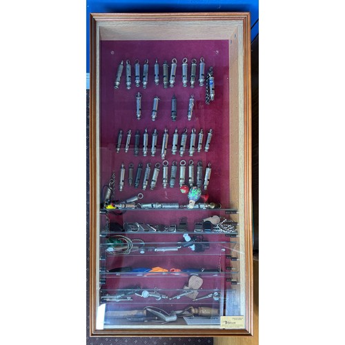 288 - CASED DISPLAY BOARD OF VARIOUS POLICE AND SPORTING WHISTLES AND SIGNAL WHISTLE