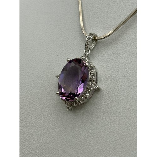 554 - SILVER OVAL AMETHYST AND CZ PENDANT ON SILVER HERRINGBONE CHAIN