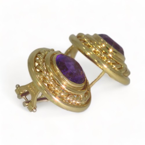 75 - A pair of 18ct yellow gold single stone amethyst set round stud earrings.
Two round faceted amethyst... 