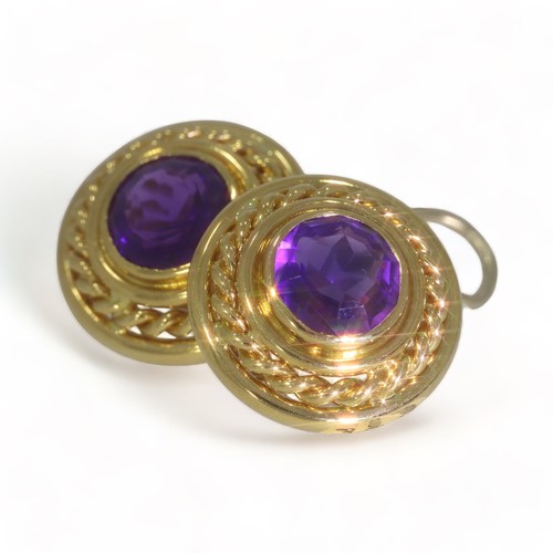 75 - A pair of 18ct yellow gold single stone amethyst set round stud earrings.
Two round faceted amethyst... 