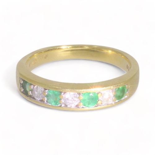 135 - A 18ct yellow gold emerald and diamond half eternity ring
4 stones, Circular faceted cut
Bulge: slig... 