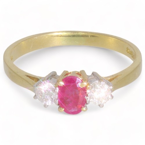 191 - An 18ct gold ruby and diamond three-stone ring.
Total diamond weight 0.25ct, stamped to band.
Hallma... 