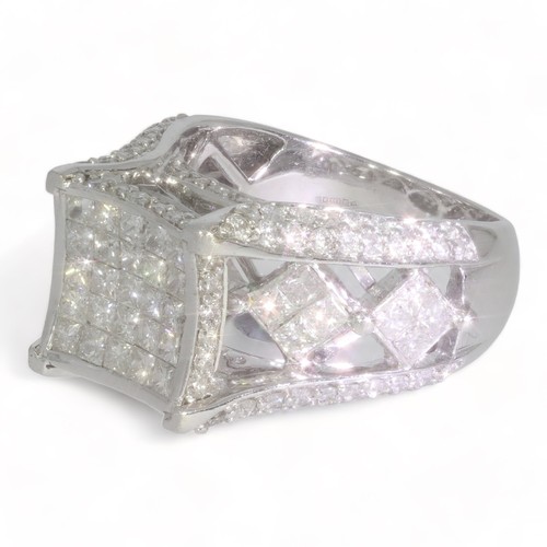 76 - A 14ct white gold multi stone diamond ring.
Princess and round brilliant cut diamonds total diamond ... 