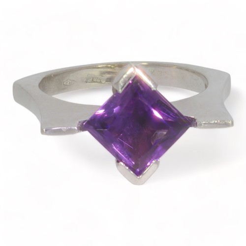 97 - A 14ct white gold single stone amethyst set dress ring.
The square faceted amethyst measures approx.... 