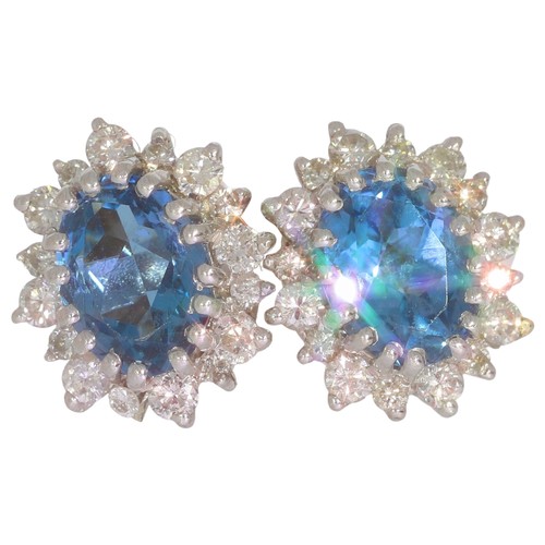 67 - 9ct gold topaz and diamond cluster earrings. Set with two oval blue topaz, and brilliant cut diamond... 