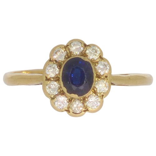 65 - 9ct gold sapphire and diamond cluster ring. Set with one oval sapphire, and brilliant cut diamonds o... 