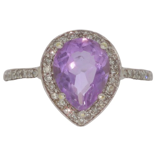 69 - 9ct white gold amethyst and diamond cluster ring. Set with one pear shape amethyst, and eight cut di... 